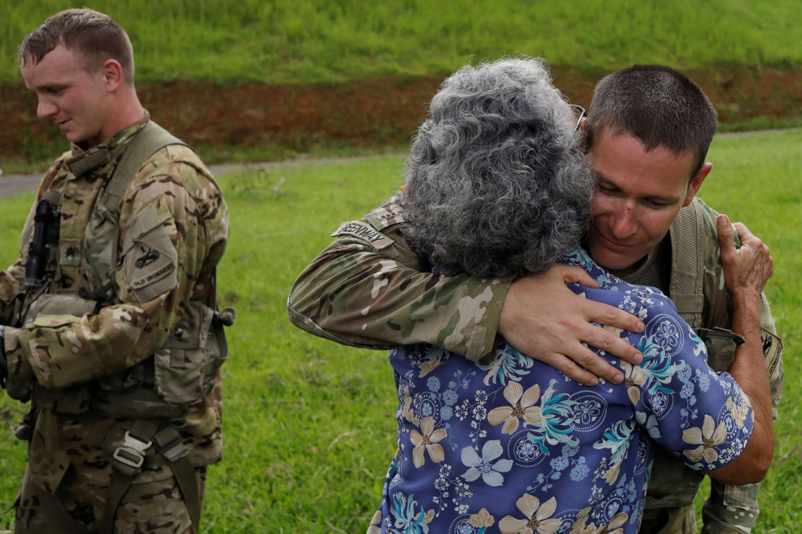 PHOTO: UH-60 Blackhawk helicopter pilot Chris Greenway receives a hug from a woman thanking him for water during recovery efforts following Hurricane Maria, in Verde de Comerio, Puerto Rico, Oct. 7, 2017.