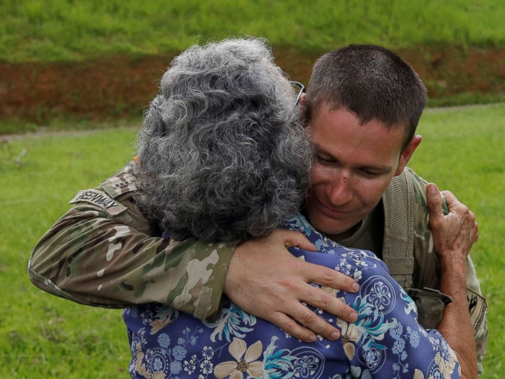PHOTO: UH-60 Blackhawk helicopter pilot Chris Greenway receives a hug from a woman thanking him for water during recovery efforts following Hurricane Maria, in Verde de Comerio, Puerto Rico, Oct. 7, 2017.