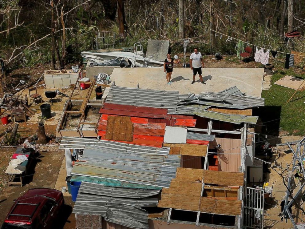 PHOTO: Residents hold their hands aloft to signal that they need water as UH-60 Blackhawk helicopters fly past during recovery efforts following Hurricane Maria, near Ciales, Puerto Rico, Oct. 7, 2017.