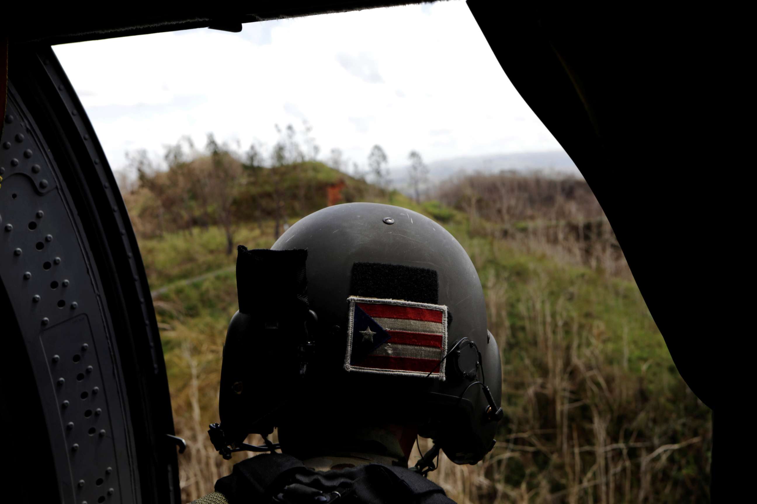 PHOTO: Sergeant First Class Eladio Tirado, who is from Puerto Rico, looks for a landing spot for a UH-60 Blackhawk helicopter during recovery efforts following Hurricane Maria near Ciales, Puerto Rico, Oct. 7, 2017.