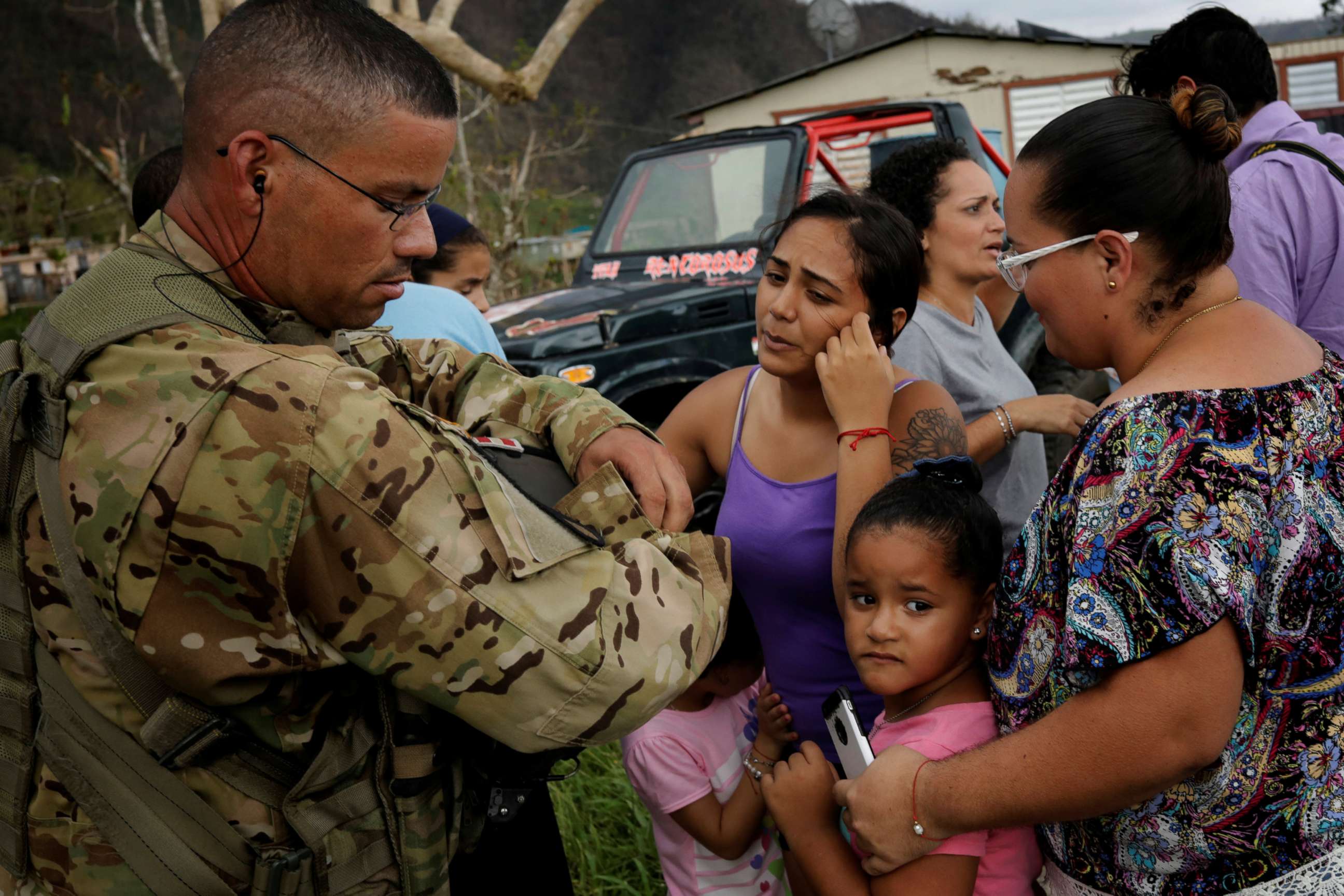 PHOTO: Sergeant First Class Eladio Tirado from the First Armored Division's Combat Aviation Brigade, who is from Puerto Rico, speaks with residents as he helps during recovery efforts following Hurricane Maria, in San Lorenzo, Puerto Rico, Oct. 7, 2017.