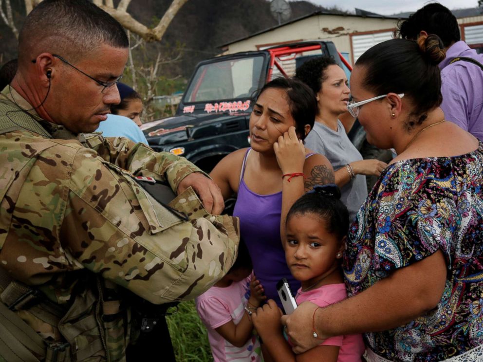 PHOTO: Sergeant First Class Eladio Tirado from the First Armored Divisions Combat Aviation Brigade, who is from Puerto Rico, speaks with residents as he helps during recovery efforts following Hurricane Maria, in San Lorenzo, Puerto Rico, Oct. 7, 2017.