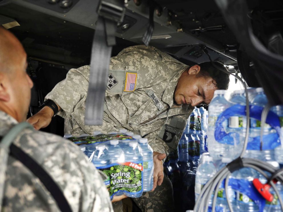 PHOTO: Crew chief Alexander Blake from 101st Airborne Divisions Dustoff unit loads water into a helicopter during recovery efforts following Hurricane Maria, in Isla Grande, Puerto Rico, Oct. 5, 2017.