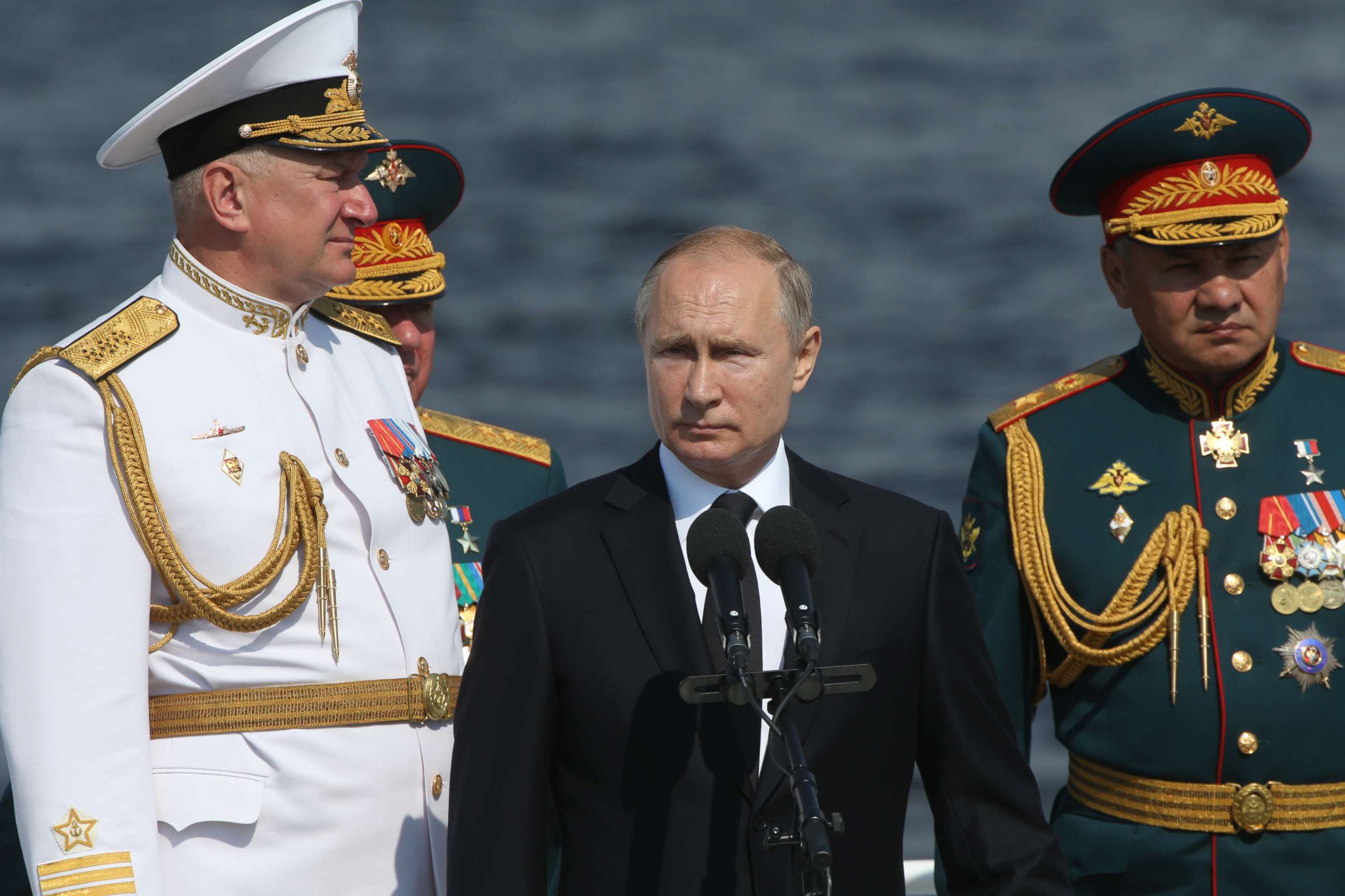 PHOTO: Russian President Vladimir Putin, Defence Minister Sergei Shoigu (R) and Chief Commander of Russian Navy Nikolai Yevmenov watch the Navy Day Parade on July 28, 2019 in Saint Petersburg, Russia.