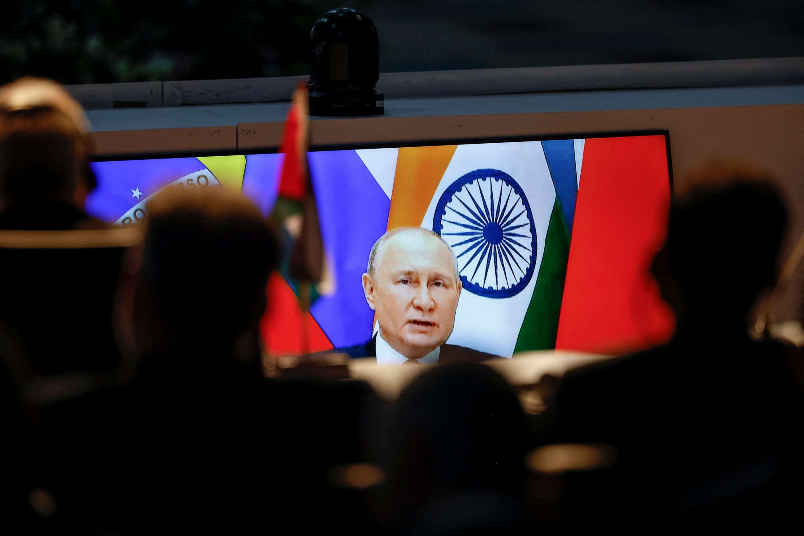 PHOTO: A screen shows Russian President Vladimir Putin virtually delivering remarks as delegates look on while attending a meeting during the 2023 BRICS Summit at the Sandton Convention Centre in Johannesburg on August 24, 2023.
