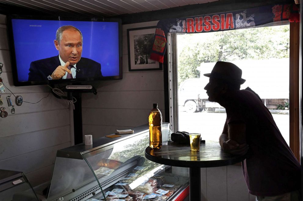 PHOTO: A bar patron watches on Russian President Vladimir Putin during a annual live broadcast call-in program outside Moscow, June 20, 2019.