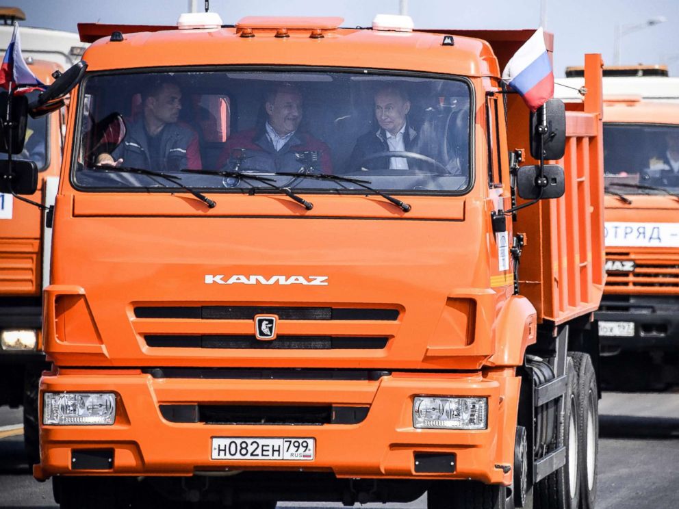 PHOTO: Russian President Vladimir Putin drives a construction truck across the new 12 mile road-and-rail Crimean Bridge over the Kerch Strait linking mainland Russia to Moscow-annexed Crimea during the opening ceremony, May 15, 2018.