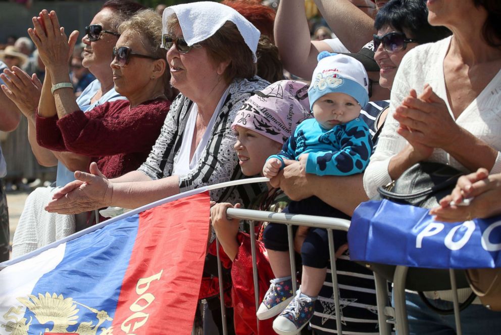 PHOTO: People attend a combined rally and concert marking the opening of a road section of the Kerch Strait (Crimean) Bridge, May 15, 2018, in Kerch, Russia.