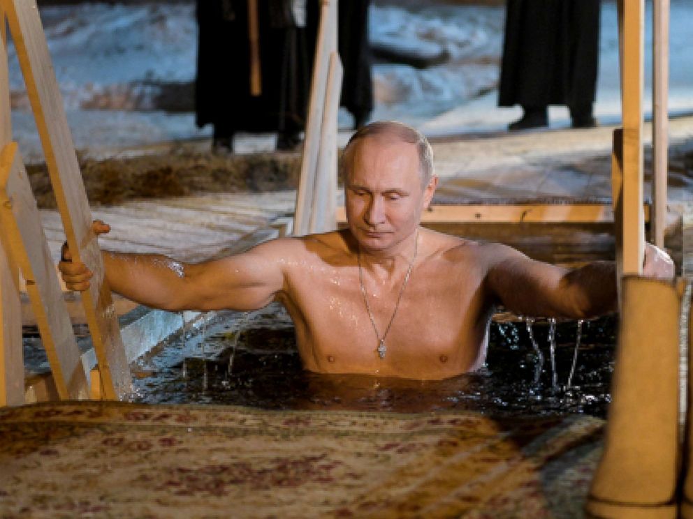 PHOTO: Russias President Vladimir Putin dips in the icy waters of Lake Seliger during the celebration of Epiphany.