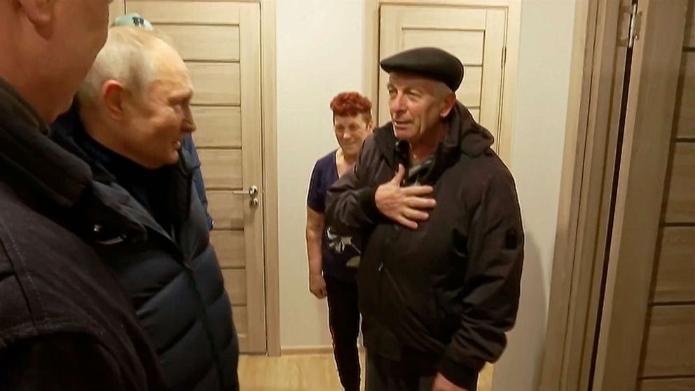 PHOTO: In this photo taken from video released by Russian TV Pool on Sunday, March 19, 2023, Russian President Vladimir Putin listens to local residents at their new flat during his visit to Mariupol in Russian-controlled Donetsk region, Ukraine.