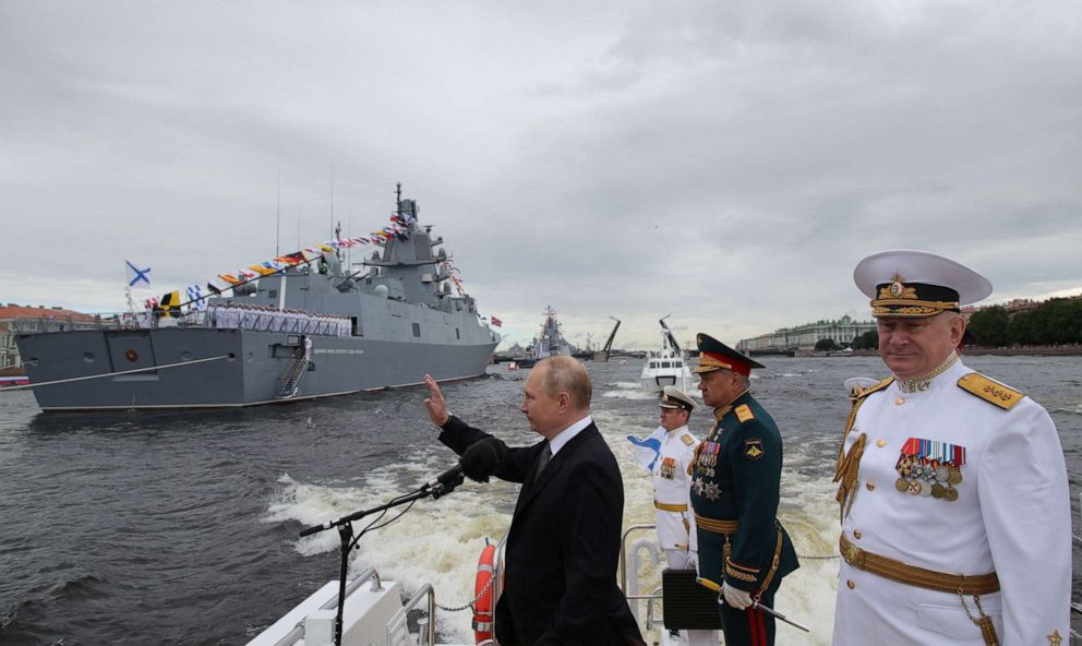PHOTO: Russia's President Vladimir Putin, Defence Minister Sergei Shoigu and head of the Russian navy Admiral Nikolai Yevmenov take part in a parade marking Navy Day in Saint Petersburg, Russia, on July 31, 2022.