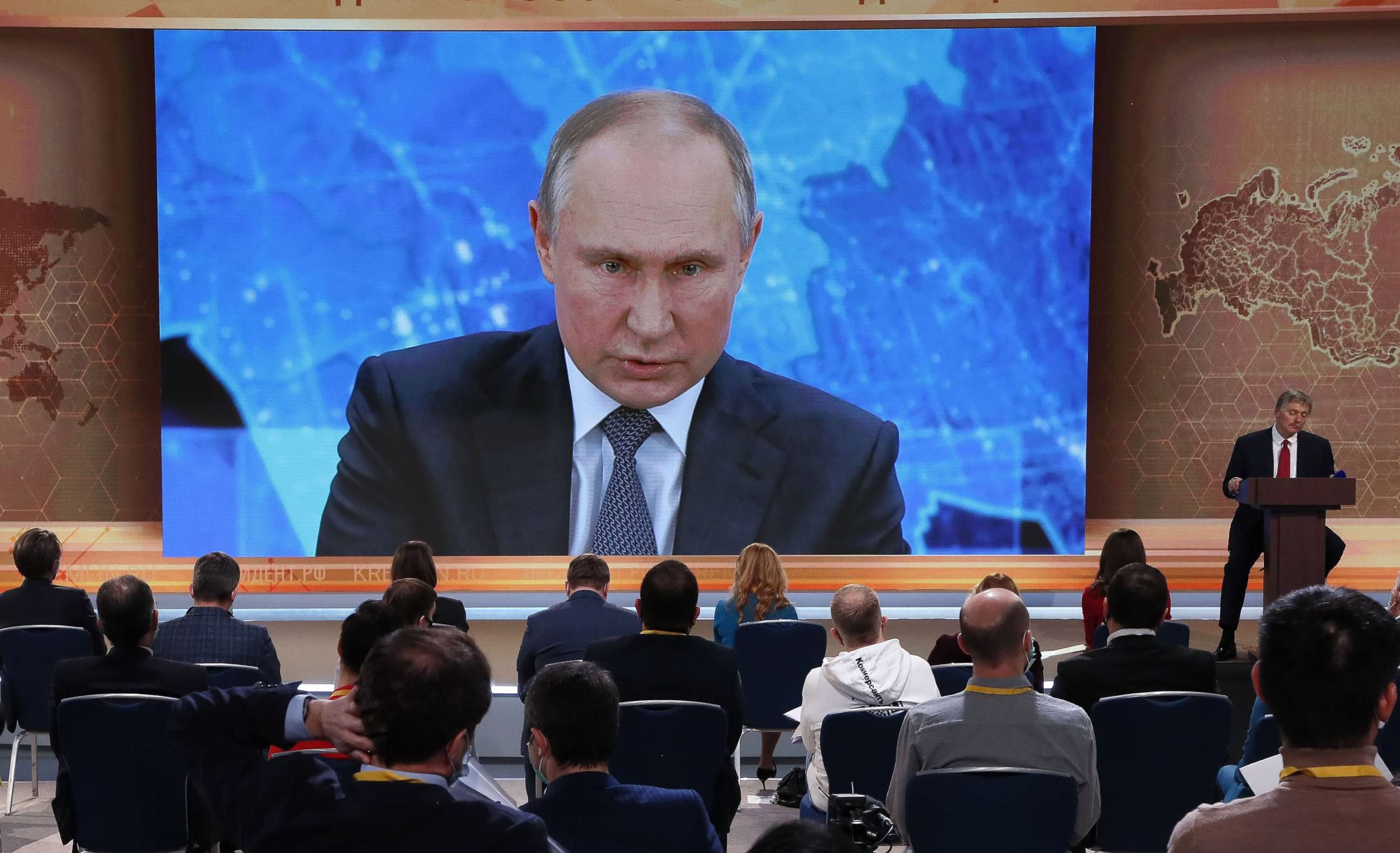 PHOTO: Journalists look at a screen showing Russian President Vladimir Putin speaking during his annual press conference via a video link from the Novo-Ogaryovo state residence, at the World Trade Center in Moscow, Dec. 17, 2020.