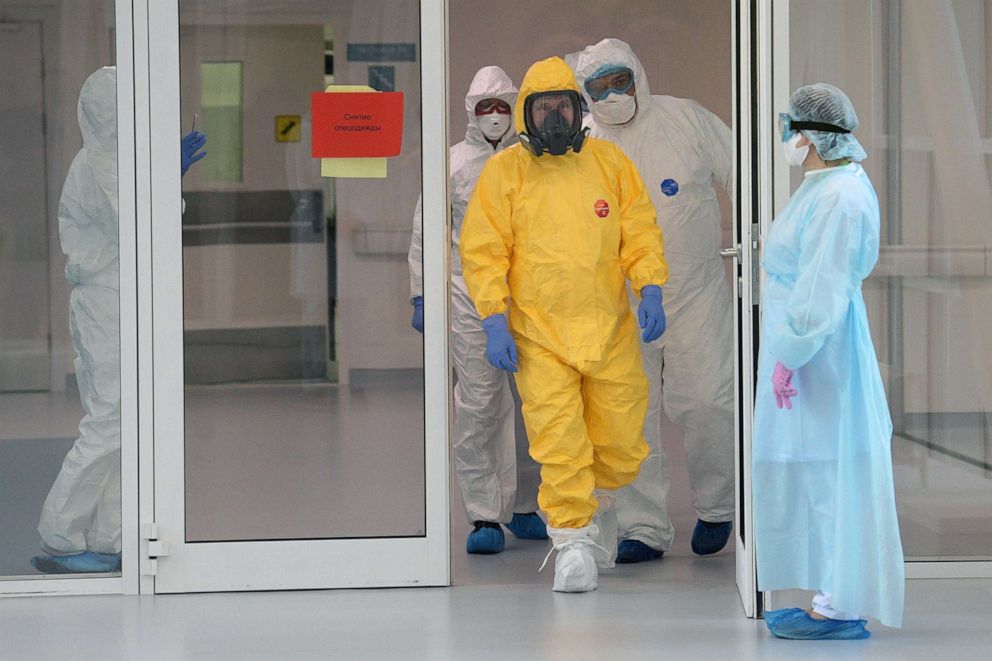 PHOTO: Russian President Vladimir Putin wears protective gear at a hospital for patients infected with coronavirus disease (COVID-19) in Russia March 24, 2020.