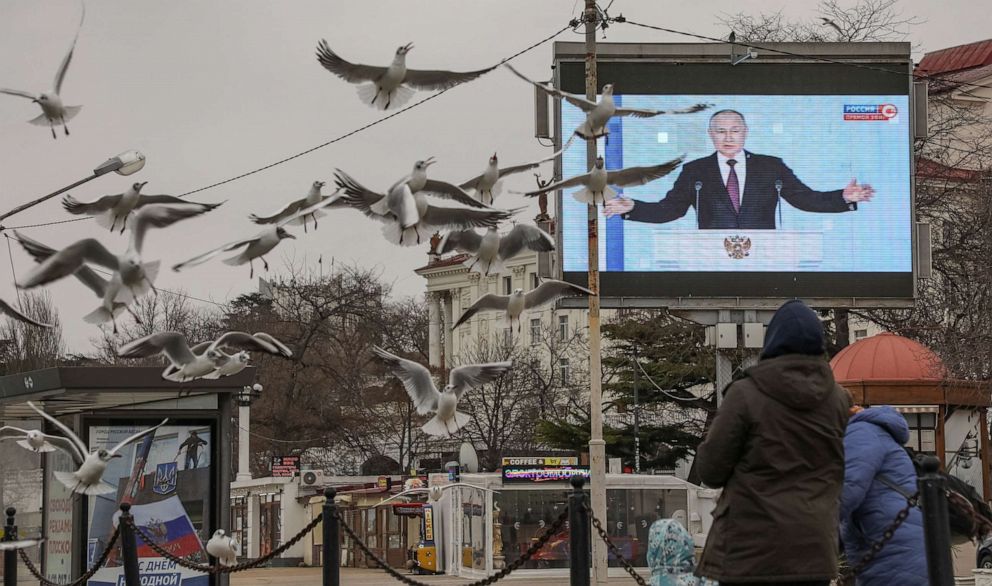 PHOTO: Russian President Vladimir Putin is seen on a screen during his annual address to the Federal Assembly, in Sevastopol, Crimea, Feb. 21, 2023.