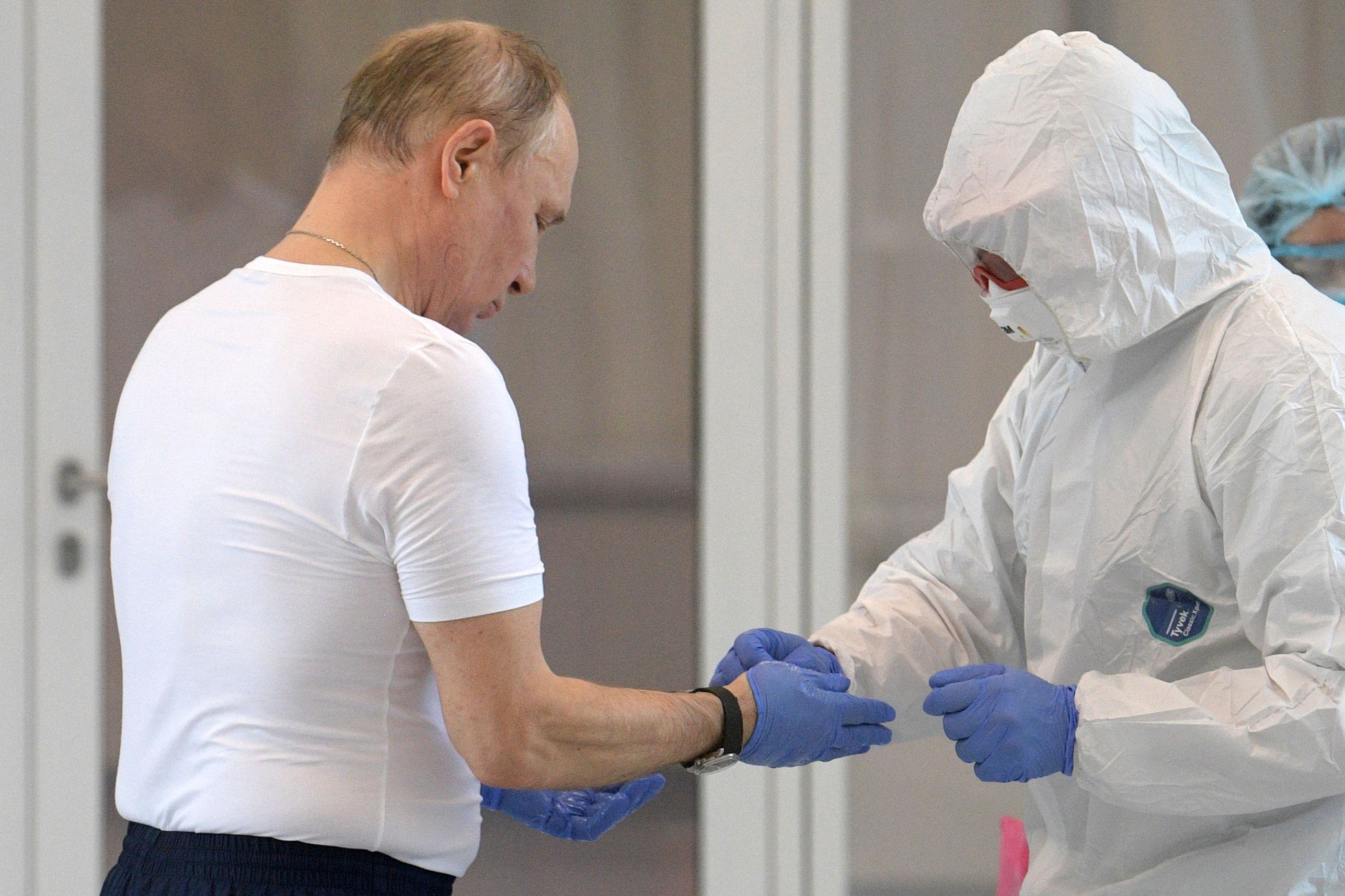 PHOTO: Russian President Vladimir Putin visits a hospital for patients infected with coronavirus disease (COVID-19) in Russia March 24, 2020.