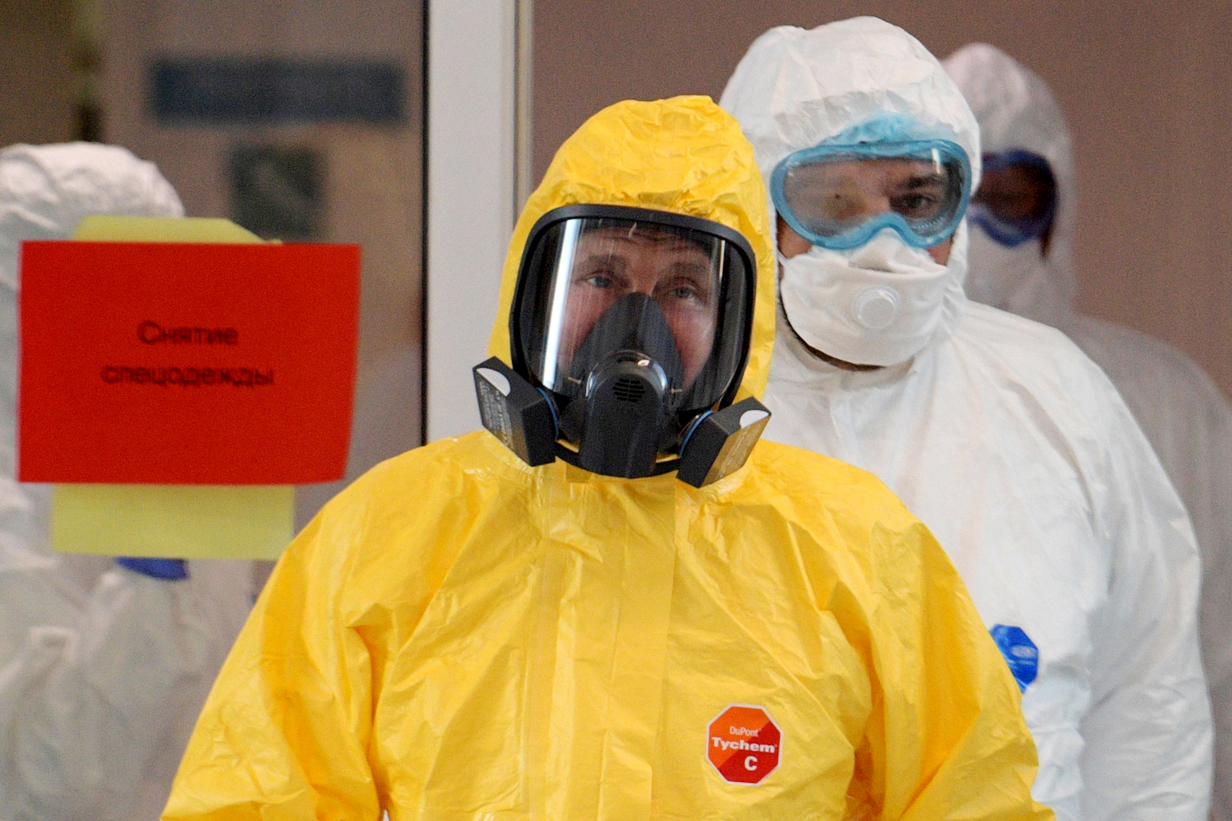 PHOTO: Russian President Vladimir Putin wears protective gear at a hospital for patients infected with coronavirus disease (COVID-19) in Russia March 24, 2020.