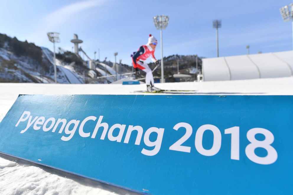 PHOTO: Cross-country skiers in action behind a band with the text "Pyeongchang 2018" in the Alpensia Cross-country Skiing Centre in Pyeongchang, South Korea, Feb. 7, 2018.