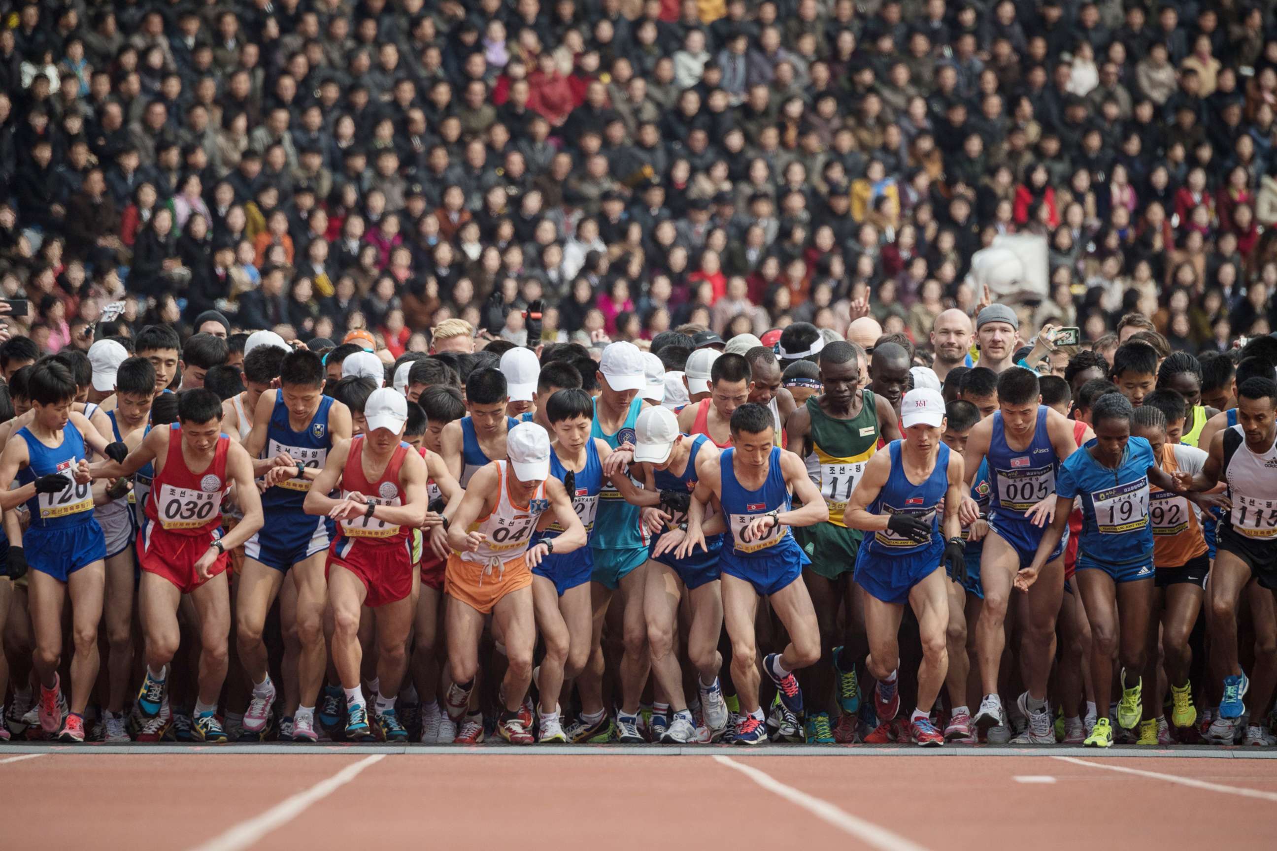 PHOTO: Competitors cross the start line of the the annual Pyongyang marathon at Kim Il Sung stadium in Pyongyang  in this April 8, 2018 file photo.