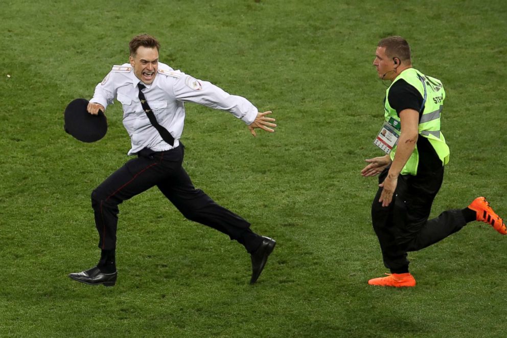 PHOTO: Pyotr Verzilov invading the pitch, runs away as a steward tries to stop him during the France and Croatia 2018 World Cup final match in the Luzhniki Stadium in Moscow, in this July 15, 2018 file photo.