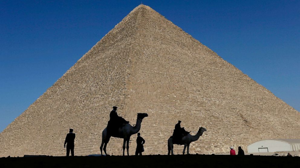 PHOTO: In this Dec. 12, 2012, file photo, policemen are silhouetted against the Great Pyramid in Giza, Egypt.