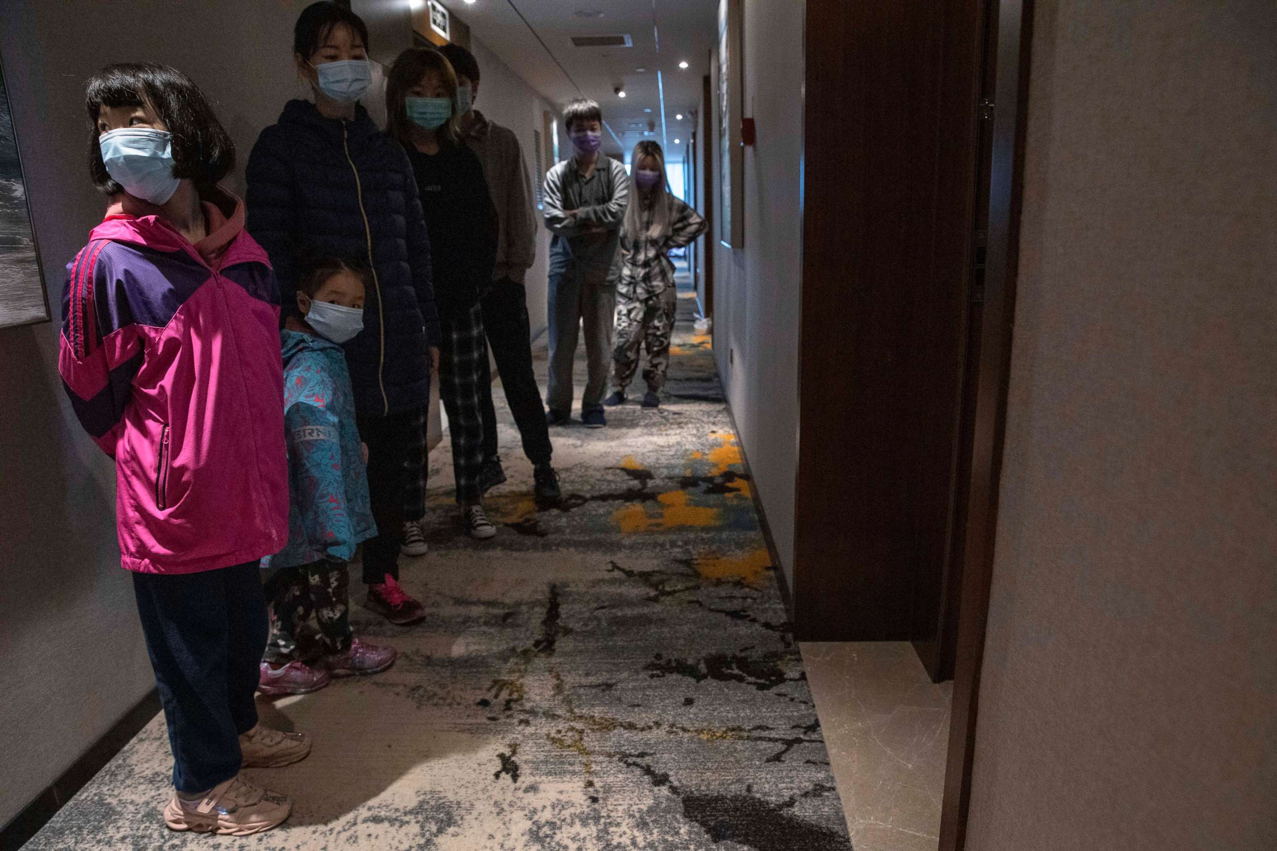 PHOTO: Quarantined returnees queue up for a COVID-19 test at a quarantine hotel in the city of Wuhan in China's central Hubei province on March 31, 2020.