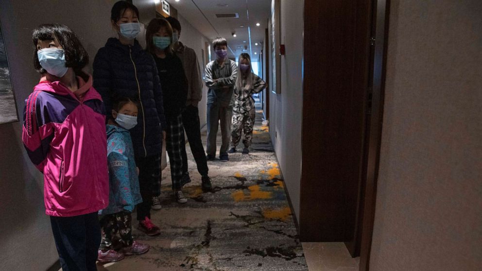 PHOTO: Quarantined returnees queue up for a COVID-19 test at a quarantine hotel in the city of Wuhan in China's central Hubei province on March 31, 2020.