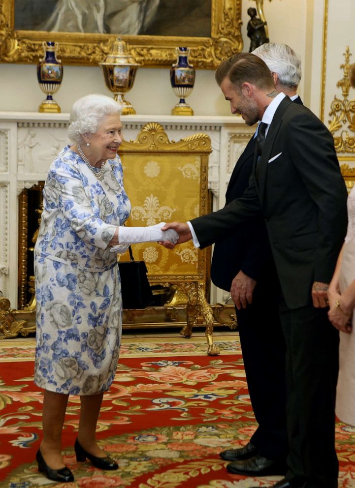 PHOTO: Queen Elizabeth II greets David Beckham as he attends the Queen's Young Leaders Awards at Buckingham Palace on June 23, 2016, in London.