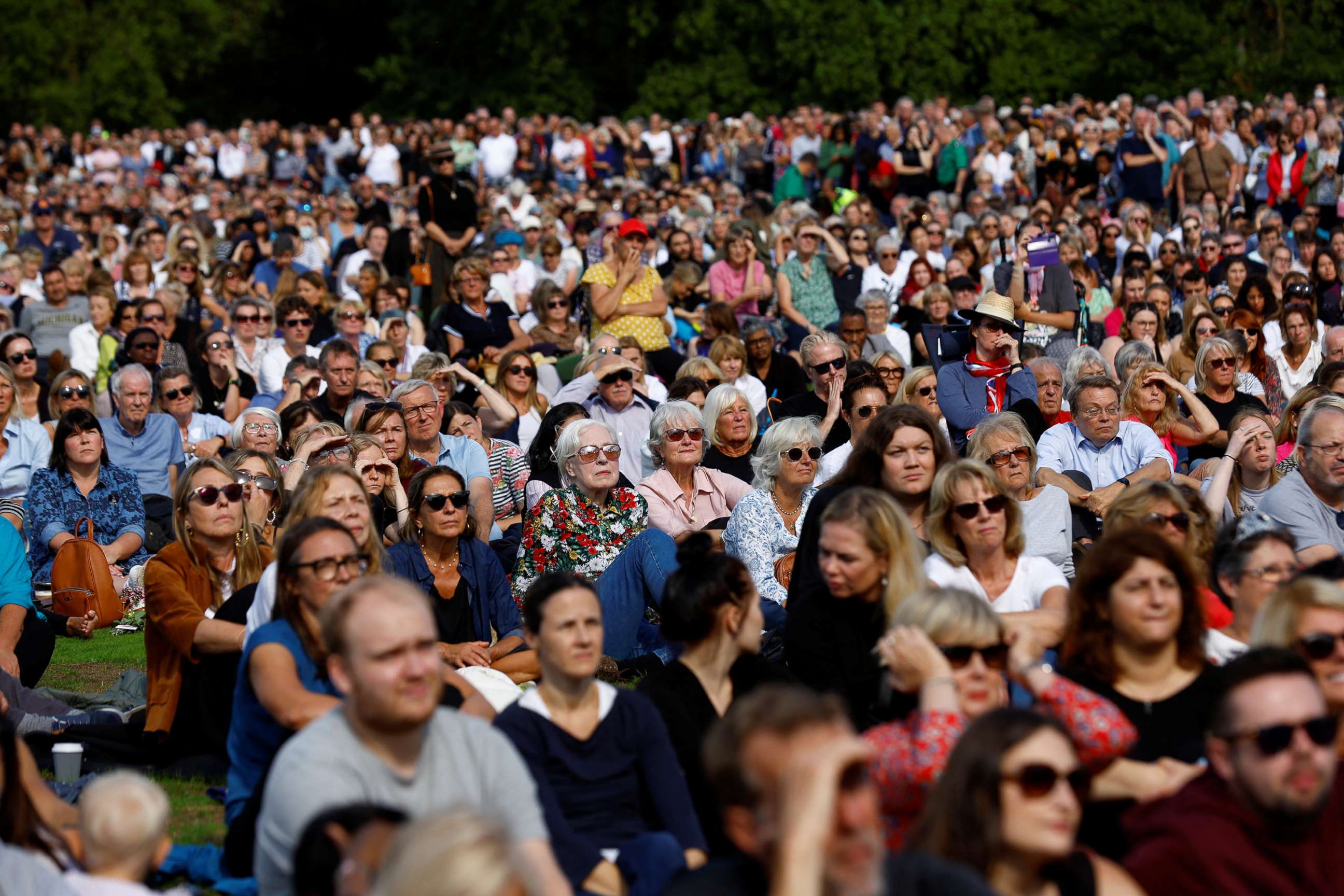 PHOTO: People gather to watch the coffin of Britain's Queen Elizabeth being transported from Buckingham Palace to Westminster Hall for her lying in state, in London,  Sept. 14, 2022.