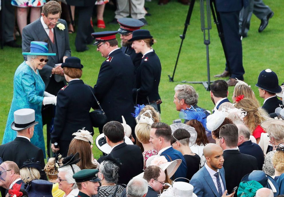 PHOTO: Queen Elizabeth II speaks to guests as she hosts a Garden Party at Buckingham Palace on May 31, 2018, in London.