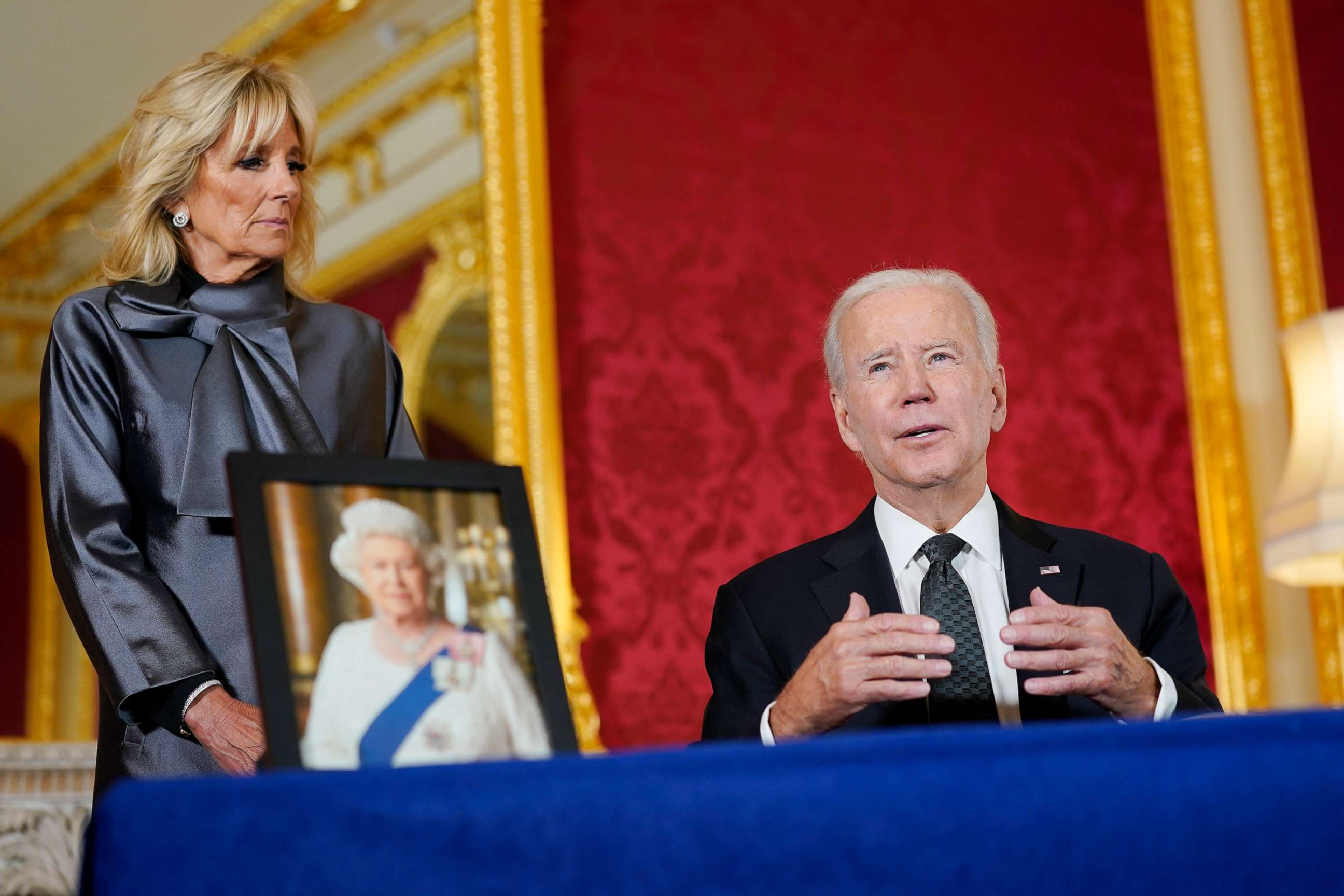 PHOTO: President Joe Biden speaks while signing a book of condolence following the death of Queen Elizabeth II  as first lady Jill Biden looks on at Lancaster House in London, , Sept. 18, 2022. 