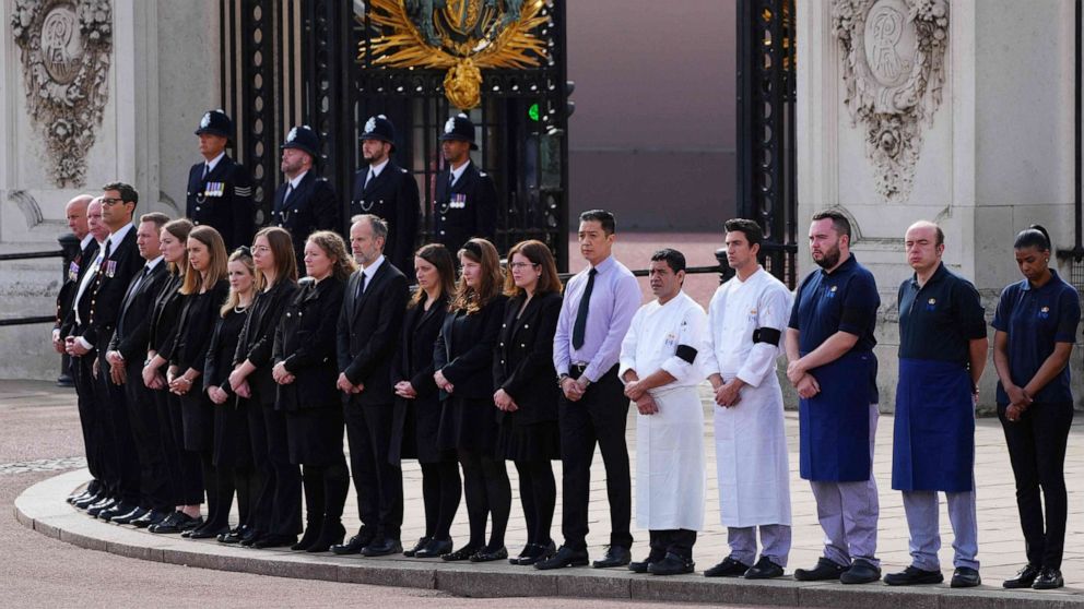 PHOTO: The staff of Buckingham Palace stood outside the gates, bidding farewell to the queen as the late monarch’s funeral procession streamed by.