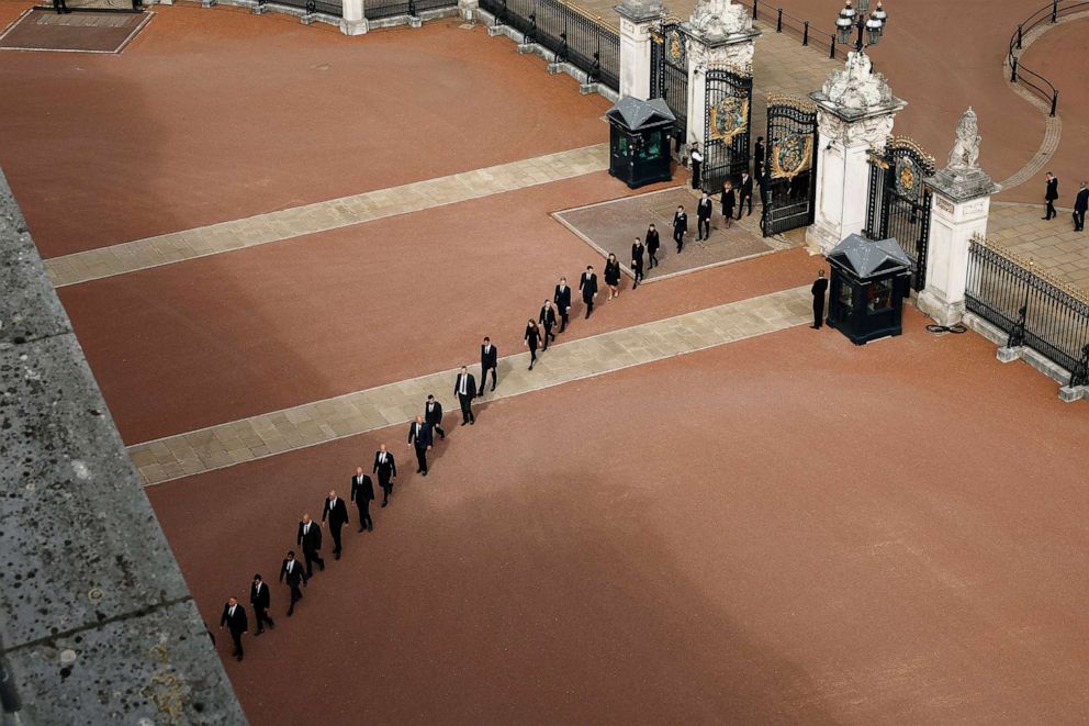 PHOTO: Buckingham Palace household staff return through the gates of Buckingham Palace after paying their respects during the State Funeral of Queen Elizabeth II on Sept. 19, 2022, in London.