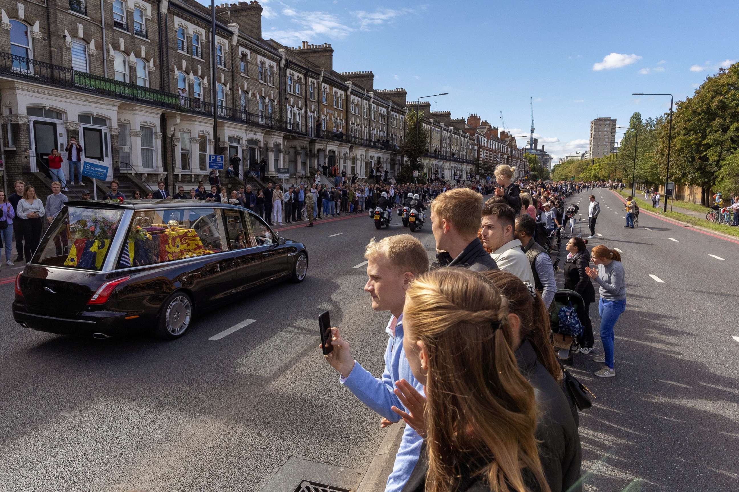 PHOTO: People watch as Britain's Queen Elizabeth's coffin is transported, on the day of her state funeral and burial, in London, Sept. 19, 2022.