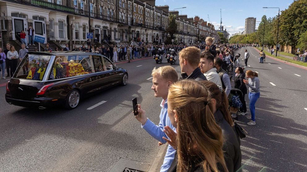 PHOTO: People watch as Britain's Queen Elizabeth's coffin is transported, on the day of her state funeral and burial, in London, Sept. 19, 2022.