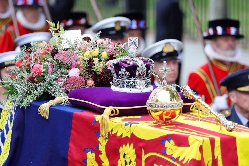 PHOTO: The coffin of Queen Elizabeth II with the Imperial State Crown, orb and sceptre resting on top is carried into Westminster Abbey on Sept. 19, 2022 in London.