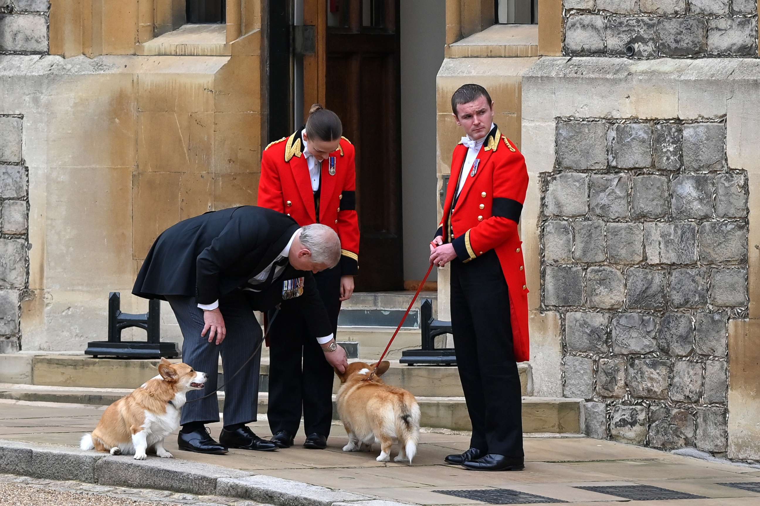 PHOTO: Prince Andrew, Duke of York speaks with members of the Royal Household and plays with the Corgis on Sept. 19, 2022 in Windsor, England.