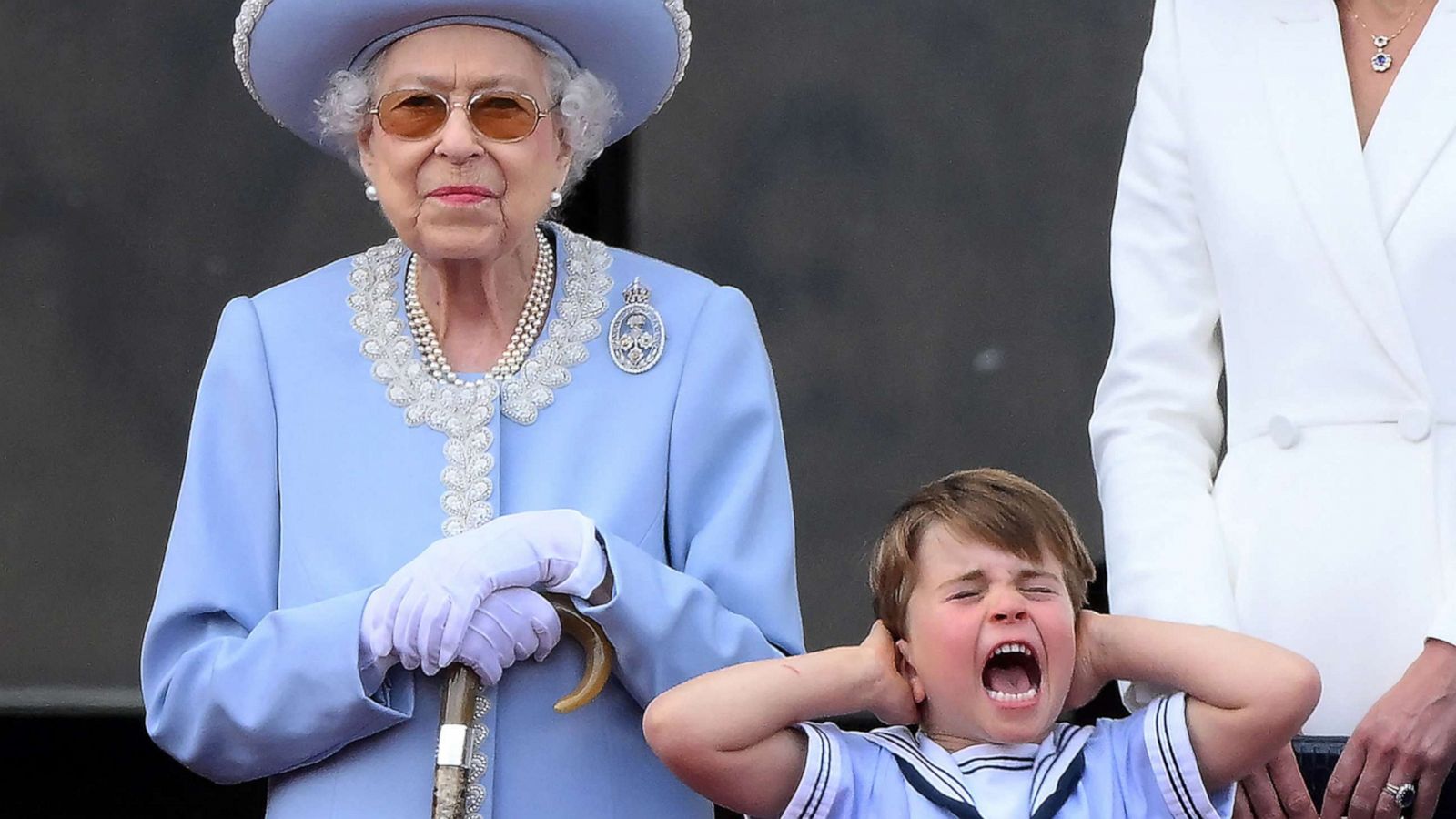 PHOTO: Britain's Prince Louis of Cambridge holds his ears as he stands next to Queen Elizabeth II to watch a flypast from Buckingham Palace balcony, as part of Queen Elizabeth II's platinum jubilee celebrations, in London, June 2, 2022.