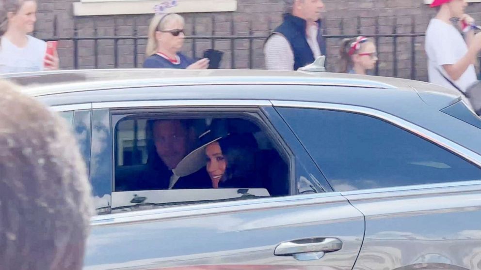 PHOTO: Britain's Prince Harry and Meghan, Duchess of Sussex are pictured in a car on the first day of Queen Elizabeth's Platinum Jubilee celebrations in London, June 2, 2022.