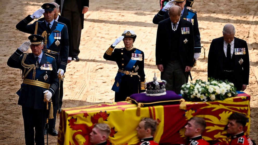 PHOTO: Britain's King Charles III, Britain's Prince William, Britain's Princess Anne, salute alongside Britain's Prince Andrew, as the coffin of Queen Elizabeth II, is carried into the Palace of Westminster, in London, Sept. 14, 2022. 
