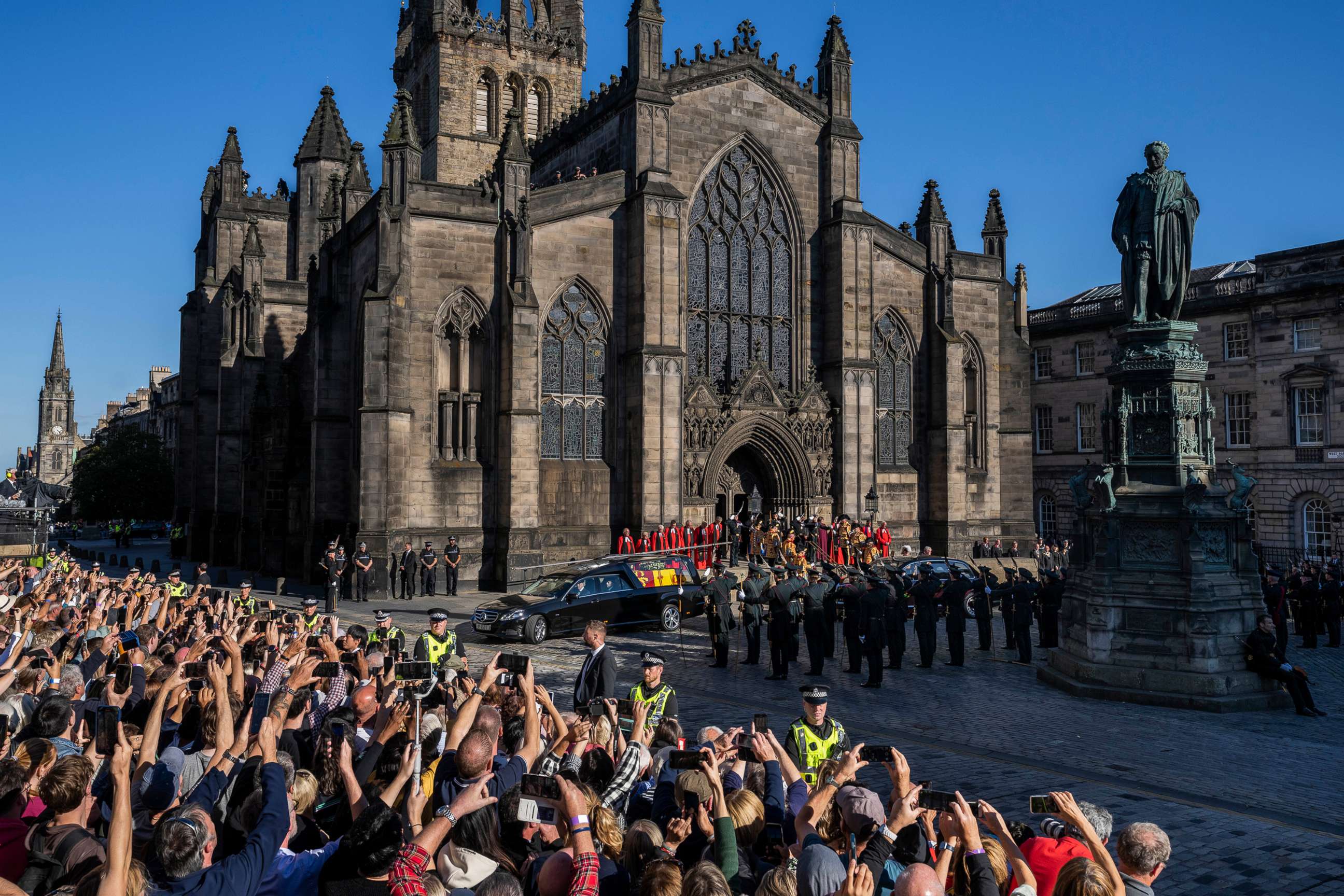 PHOTO: People take photos with their mobile phones as the Queens cortege with the hearse carrying Queen Elizabeth's coffin departs from St Giles Cathedral en route to Edinburgh Airport in Edinburgh, Scotland, Sept. 13, 2022.