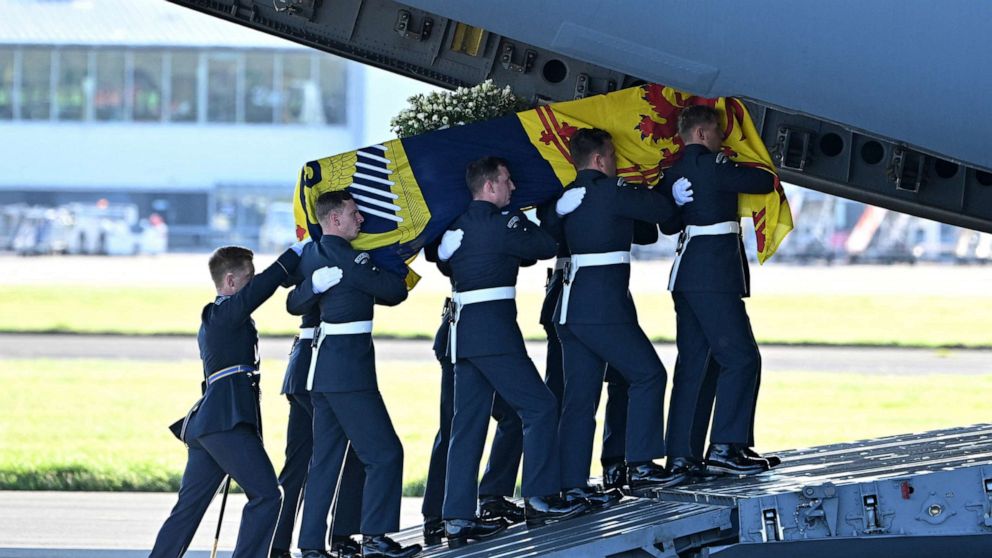 PHOTO: Pallbearers carry the coffin of Queen Elizabeth II, draped in the Royal Standard of Scotland, into a RAF C17 aircraft at Edinburgh airport on Sept. 13, 2022, before it is transported to Buckingham Palace in London.