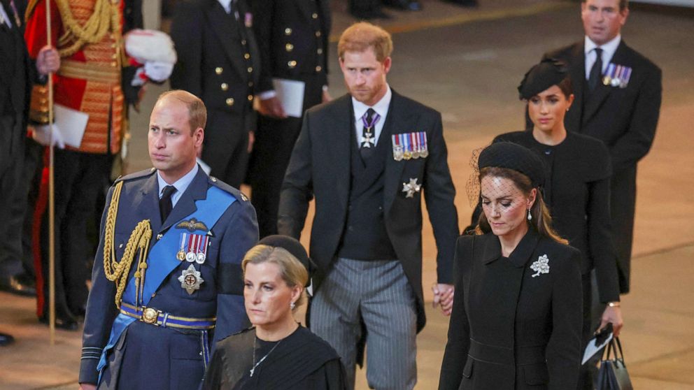 PHOTO: Prince William, Kate, Princess of Wales, Prince Harry and Meghan, Duchess of Sussex walk as the procession with the coffin of Britain's Queen Elizabeth arrives at Westminster Hall in London, Sept. 14, 2022.