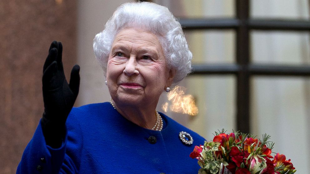 PHOTO: Britain's Queen Elizabeth II looks up and waves to members of staff of The Foreign and Commonwealth Office as she ends an official visit, which is part of her Jubilee celebrations in London, Dec. 18, 2012.