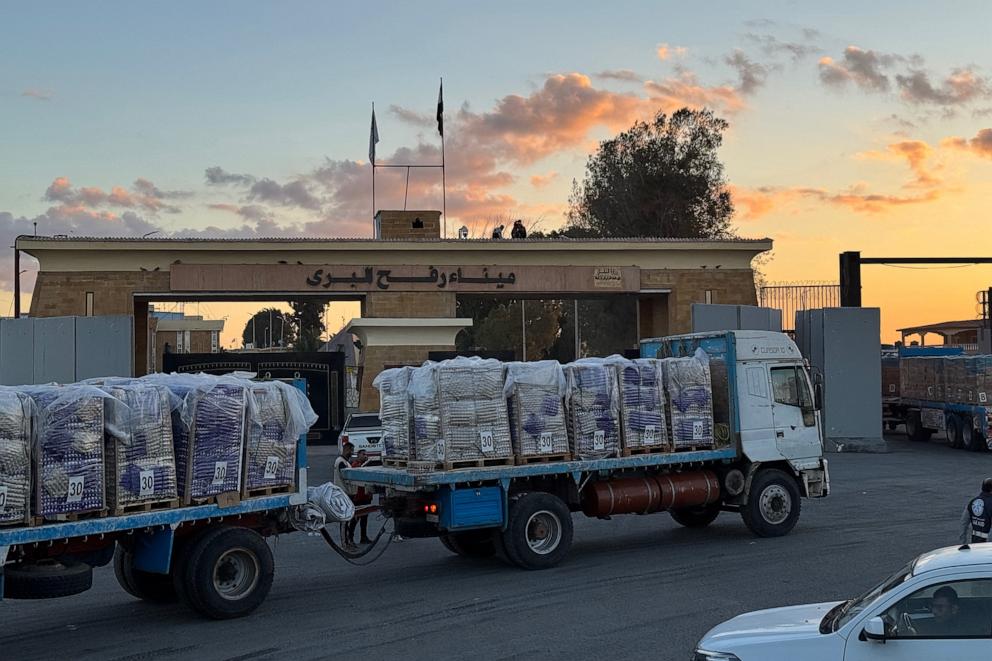 PHOTO: Trucks loaded with humanitarian aid on the Egyptian side of the Rafah crossing wait to get cross into the Gaza Strip early on Oct. 15, 2025.