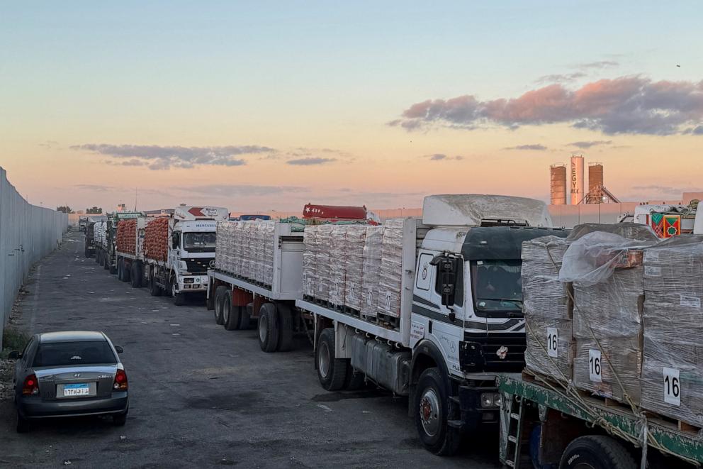 PHOTO: Trucks loaded with humanitarian aid on the Egyptian side of the Rafah crossing wait to cross into the Gaza Strip early on Oct. 15, 2025.