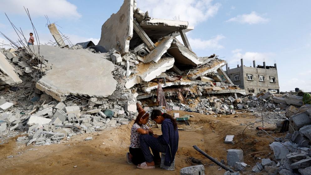 PHOTO: Palestinian children sit next to the site of an Israeli strike on a house, amid the ongoing conflict between Israel and the Palestinian Islamist group Hamas, in Rafah, in the southern Gaza Strip, April 21, 2024.