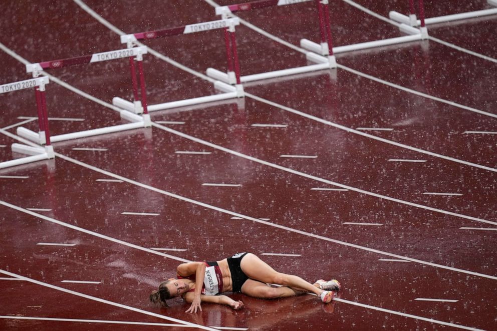 PHOTO: Sara Petersen, of Denmark, lies on the track after a fall in a semifinal of the women's 400-meter hurdles at the 2020 Summer Olympics, Aug. 2, 2021, in Tokyo.