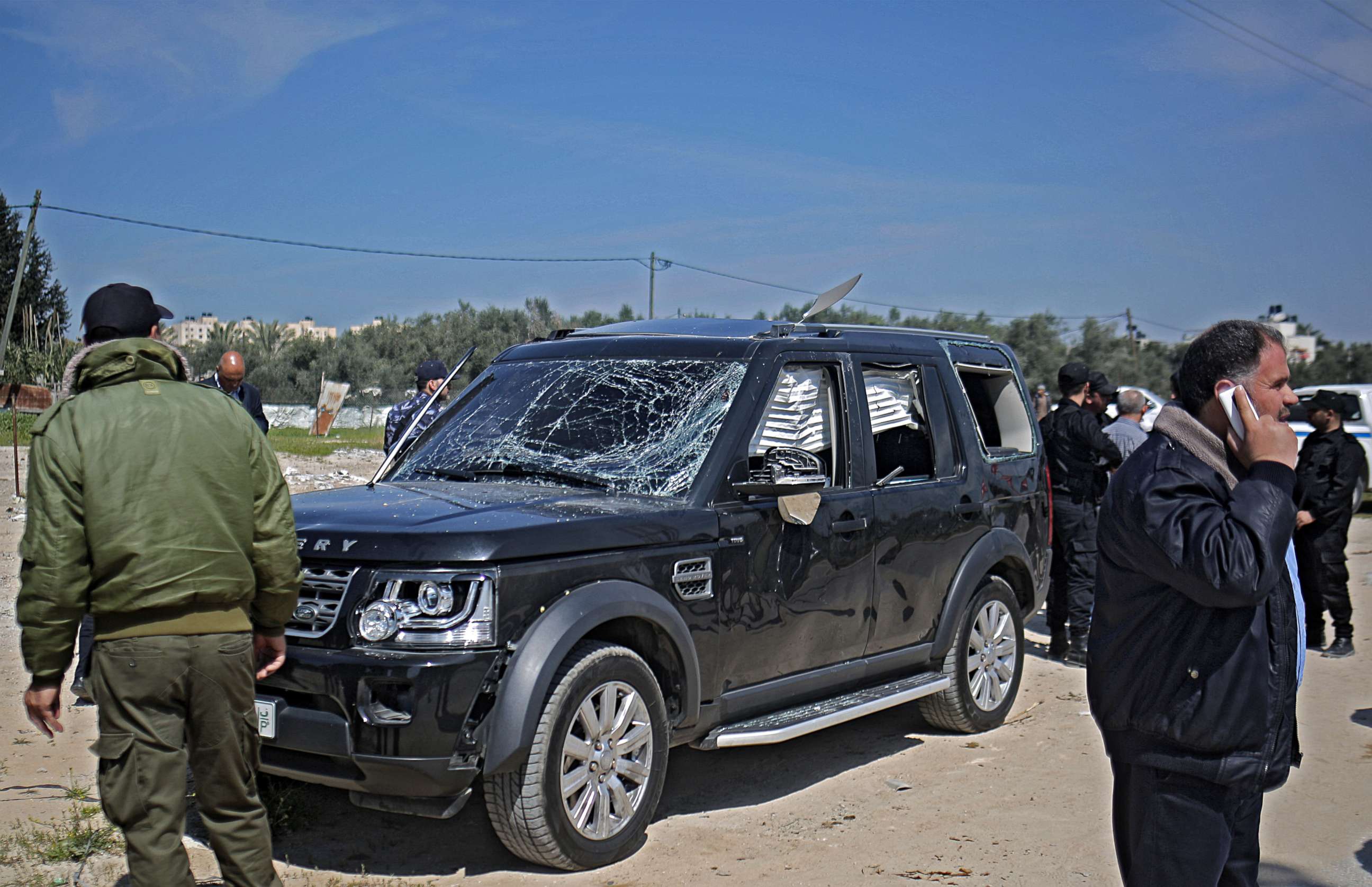 PHOTO: Hamas security officials inspect one of the cars of Palestinian Prime Minister Ramil Hamdallah's convoy that was targeted in an attack after his arrival in Beit Hanun town, the northern Gaza Strip, March 13, 2018.
