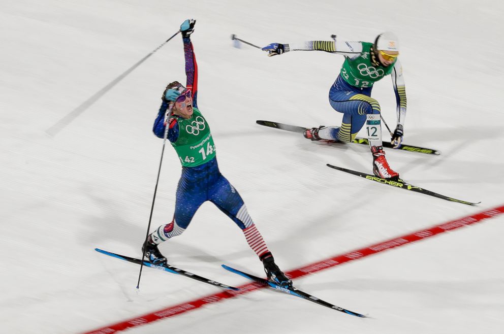 PHOTO: American Jessica Diggins celebrates after crossing the finish line and winning the gold medal past in the women's team sprint freestyle cross-country skiing final, Feb. 21, 2018. Stina Nilsson, of Sweden is in the background.