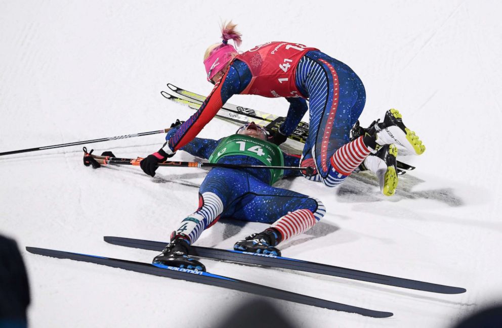 PHOTO:Americans Jessica Diggins, bottom, and Kikkan Randall celebrate after Diggins crossed the finish line giving them the gold medal in the womens cross country team sprint free final, Feb. 21, 2018.